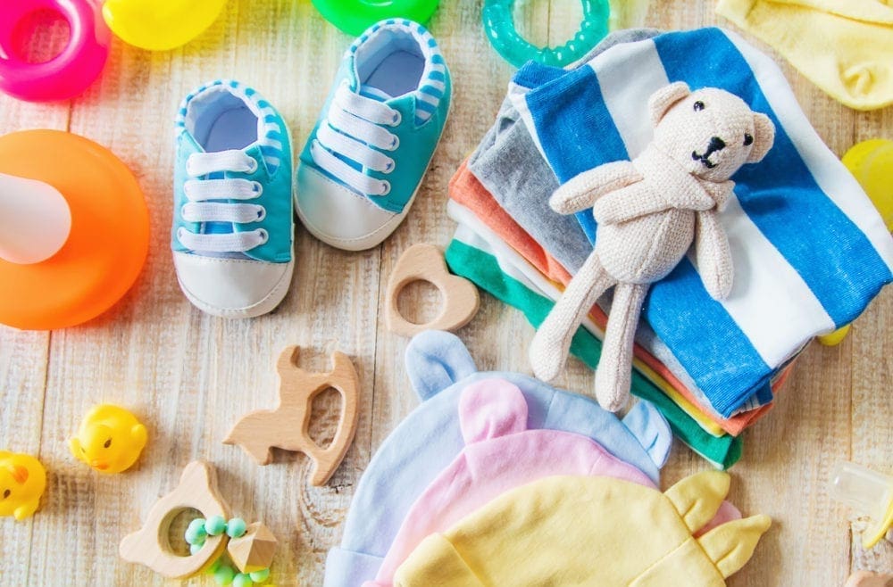 a collection of baby clothes and toys