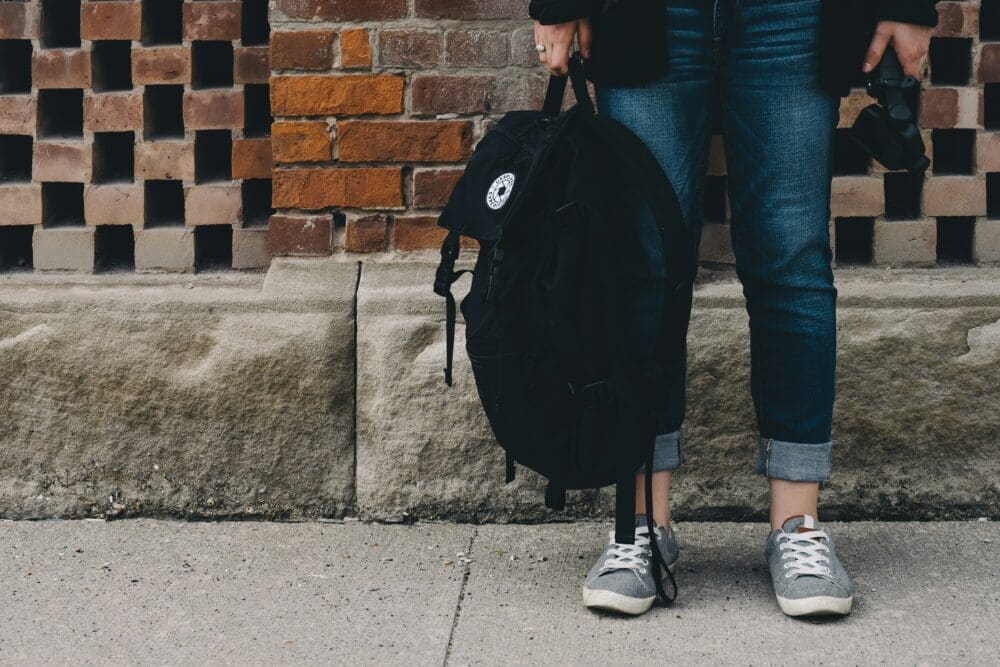 Kid holding backpack
