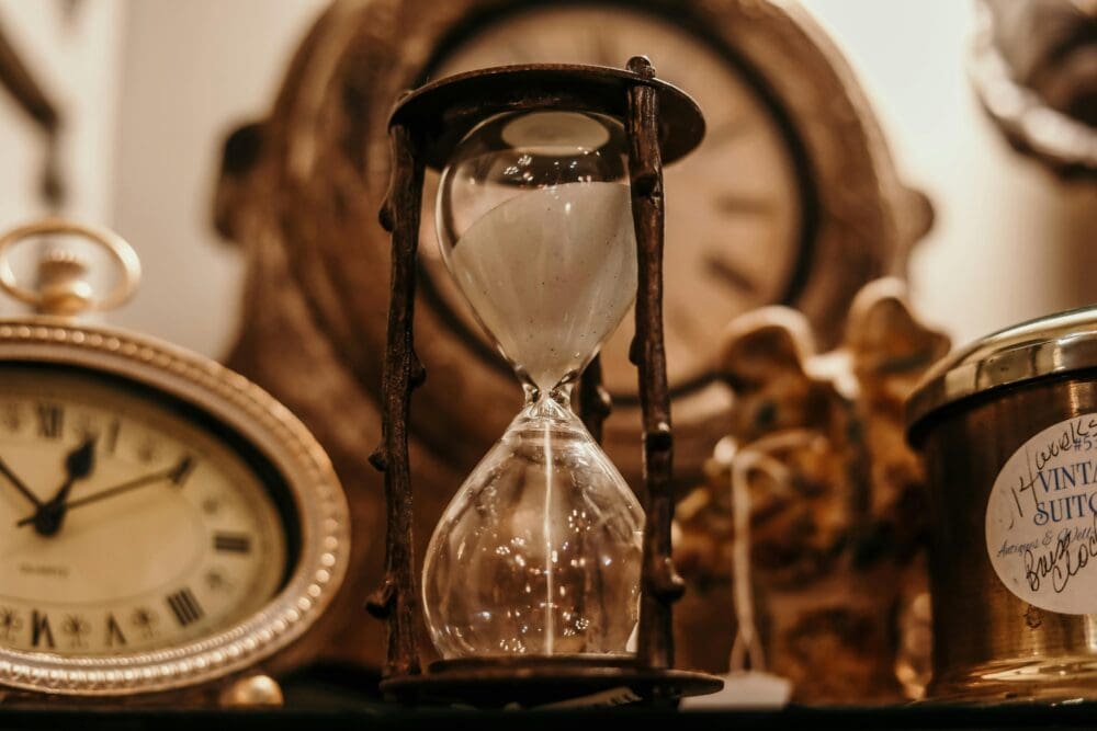 antique sand timer sitting on shelf